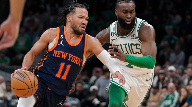 Jalen Brunson drives past Jaylen Brown during a New York Knicks vs Boston Celtics NBA game.
